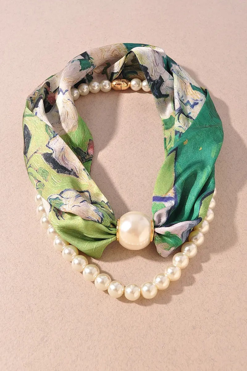 Green floral headband with pearls on a beige background