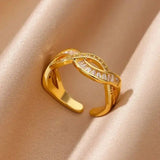 Gold-plated sparkle ring with intertwined band and adjustable fit, featuring sparkling stones for a luxurious everyday look