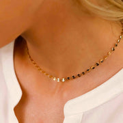 Layered gold circle choker necklace with cubic zirconia, ideal for stacking or wearing solo for a minimal look.