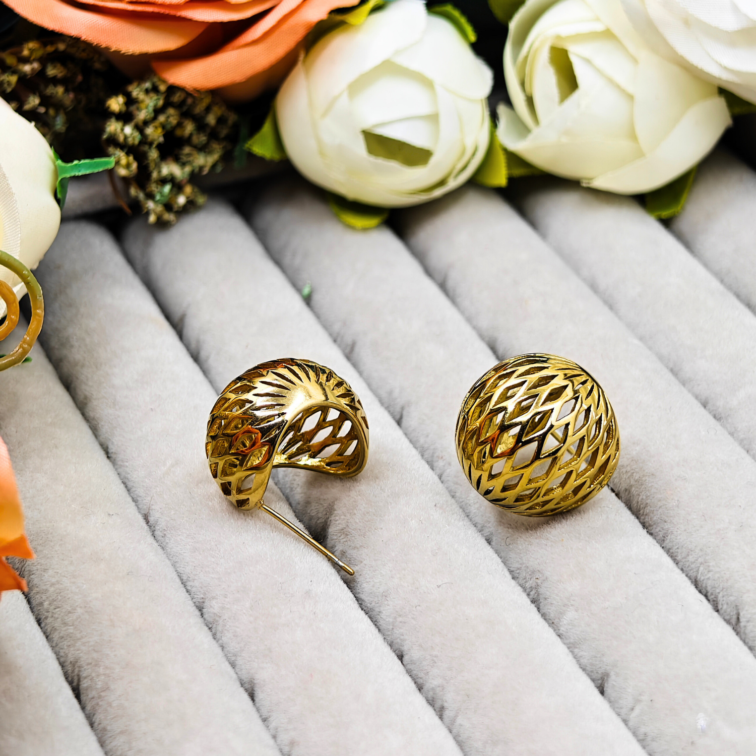 Stylish 18k gold-plated flower stud earrings featuring an open airy design and bold modern look.