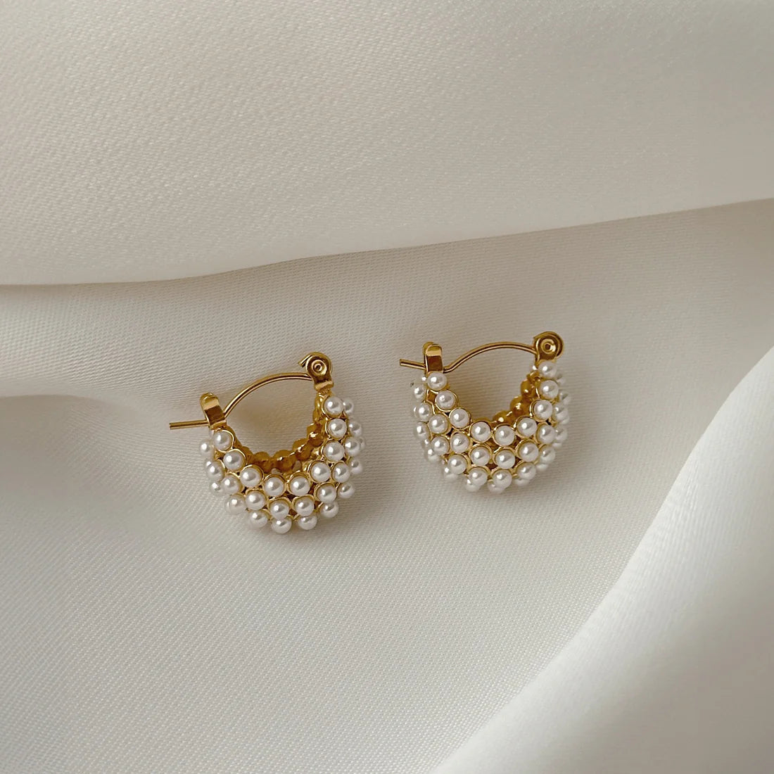 Stylish Mini Glow U Pearl Earrings, featuring gold-plated hoops and pearls, designed for a minimalist yet luxurious feel.