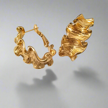 Gold hoop earrings on a gray background - waterproof, tarnish-free, hypoallergenic gold plated jewelry from Ezra Gems