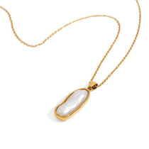 Ocean water pearl pendant necklace with glowing pearl in gold frame, elegant 18k gold jewelry for everyday or special occasions
