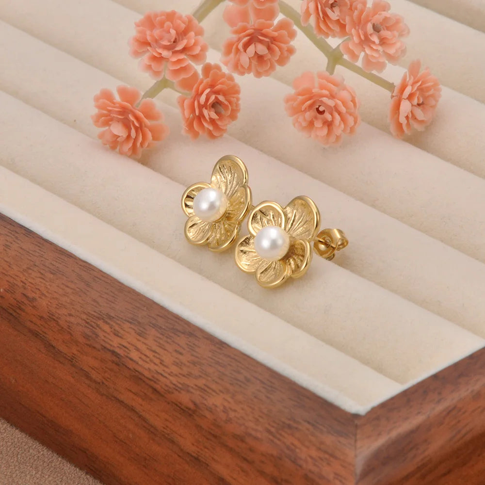Radiant pearl stud earrings with shiny gold flower petals and a luxe oversized design