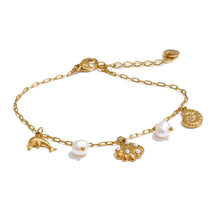 Gold sea charms pearl bracelet with dolphin, shell, and natural pearl on stainless steel chain, perfect for ocean lovers.

