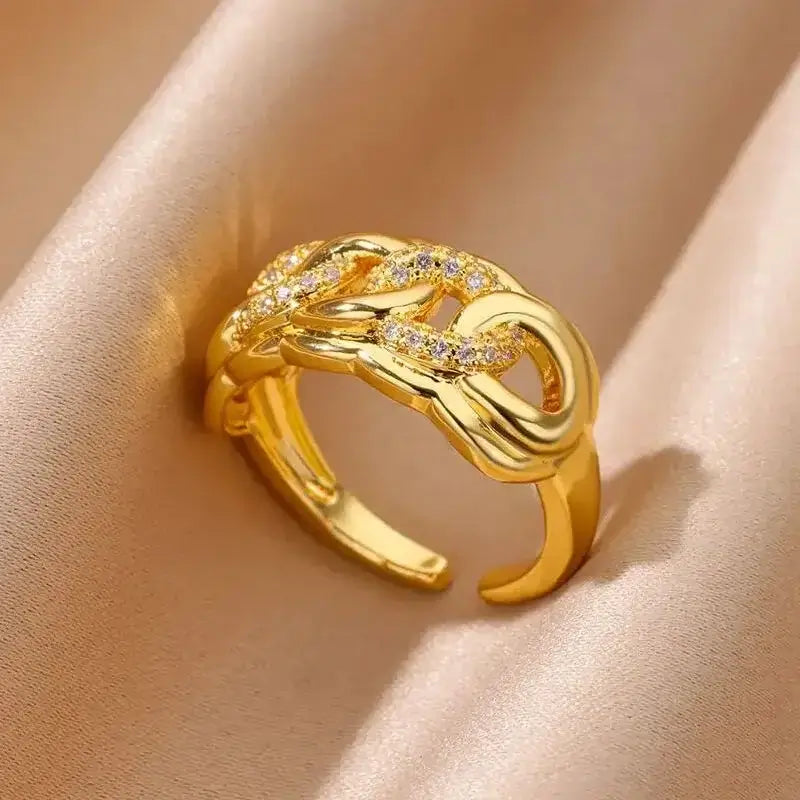Gold-plated sparkling knots ring with interwoven design and crystal accents, adjustable fit, elegant for everyday or special occasion wear.

