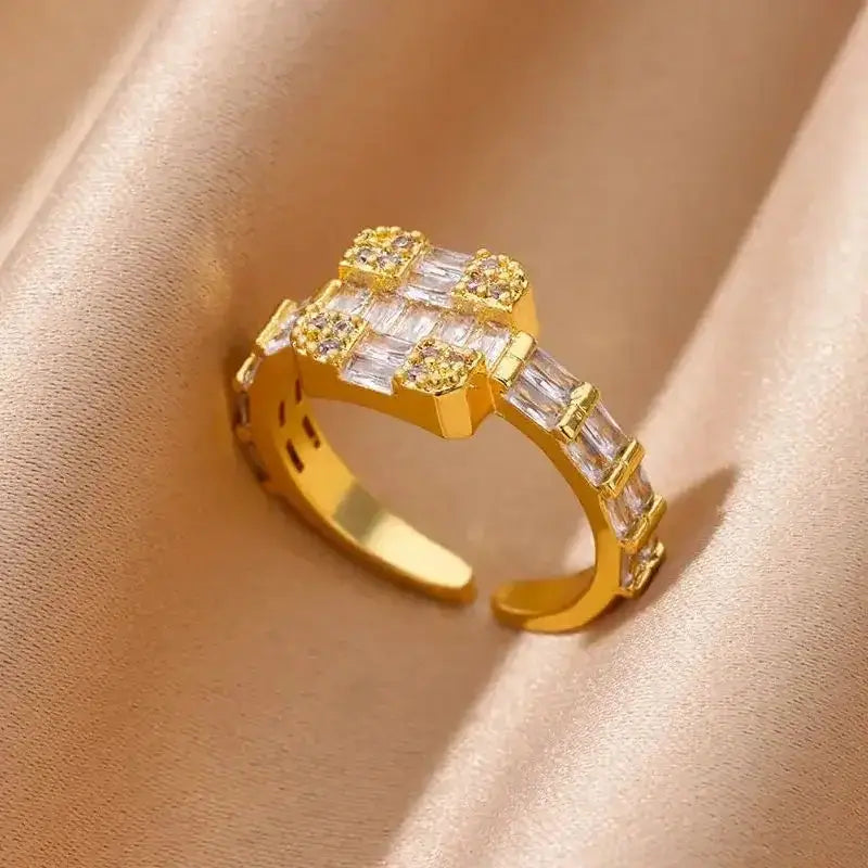 Elegant square crossed gold ring featuring baguette-cut stones in a grid pattern, adjustable for a sleek and stylish finish.