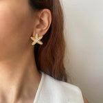 Starfish stud earrings in gold with soft pearl accents, lightweight and perfect for beach lovers or summer-inspired outfits

