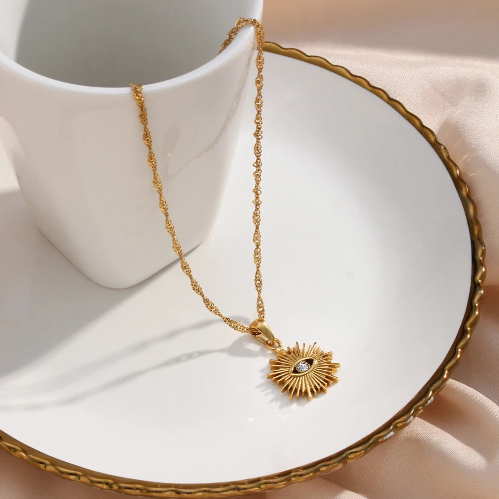 Sparkling Sunburst Evil Eye Necklace with gold detailing and cubic zirconia, symbolizing protection and clarity for daily wear.
