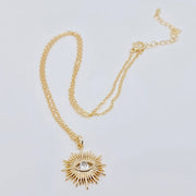 Gold-plated sunburst evil eye pendant necklace with cubic zirconia center, offering stylish protection and elegance for everyday wear.