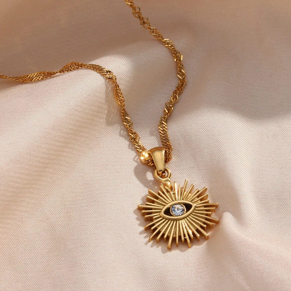 Elegant Sunray Evil Eye Necklace with gold sunburst and cubic zirconia, designed for protection, clarity, and everyday wear.