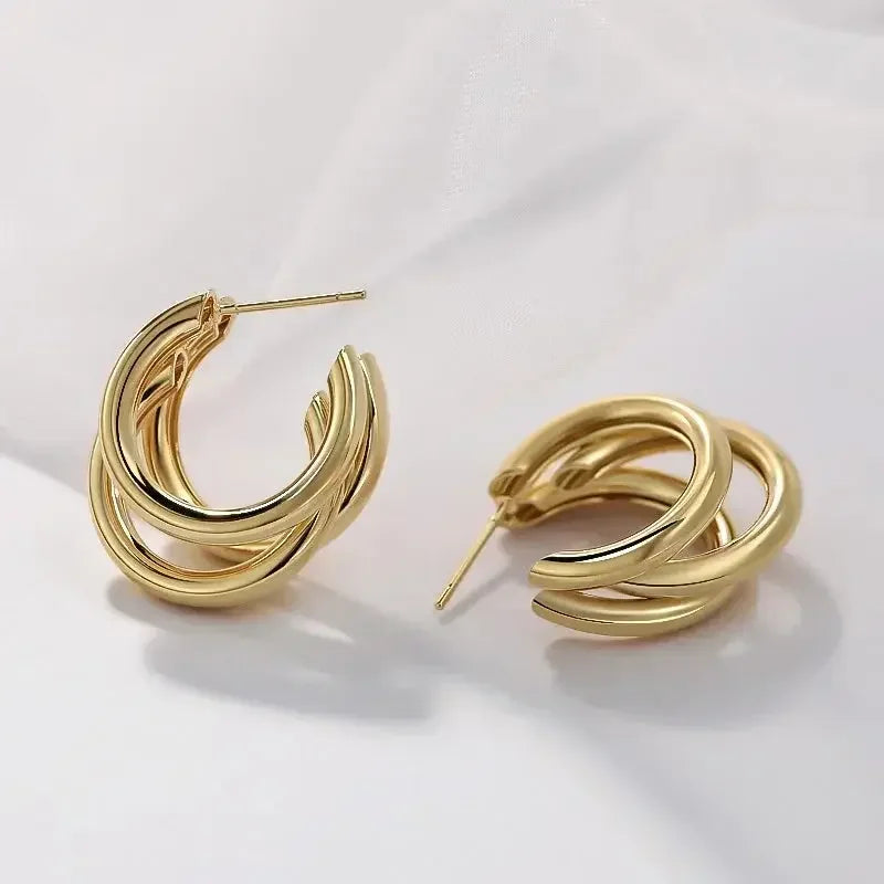 Elegant Triple Hoop Gold Earrings, 18K gold-plated, featuring a layered design that adds a modern touch to any outfit, perfect for everyday or special occasions.