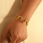 Modern wave-shaped gold cuff bracelet with flexible stainless steel wire, waterproof and tarnish-free for stylish everyday wear