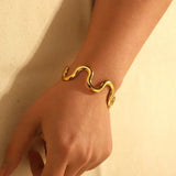Modern wave-shaped gold cuff bracelet with flexible stainless steel wire, waterproof and tarnish-free for stylish everyday wear